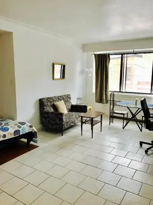 a living room with a couch and a table at Stylish Montreal Apartment: Comfortable Stay in the Golden Square Mile in Montréal