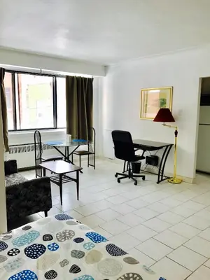a living room with a table and chairs at Stylish Montreal Apartment: Comfortable Stay in the Golden Square Mile in Montréal