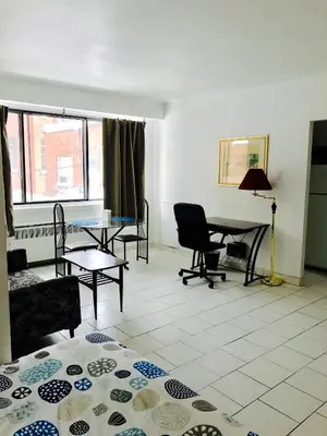 a living room with a table and chairs at Stylish Montreal Apartment: Comfortable Stay in the Golden Square Mile in Montréal