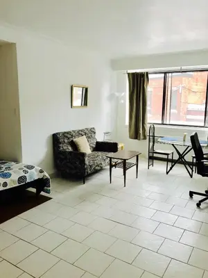 a living room with a couch and a table at Stylish Montreal Apartment: Comfortable Stay in the Golden Square Mile in Montréal