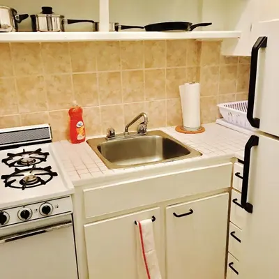 a kitchen with a sink and a stove at Stylish Montreal Apartment: Comfortable Stay in the Golden Square Mile in Montréal