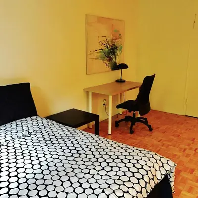 a bedroom with a bed and a table and chairs at Stylish Montreal Apartment: Comfortable Stay in the Golden Square Mile in Montréal