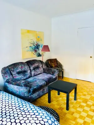 a living room with a couch and a coffee table at Stylish Montreal Apartment: Comfortable Stay in the Golden Square Mile in Montréal