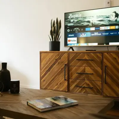 a television on top of a wooden entertainment center at HRésidences Modern Condo on MAIN St Laurent Blvd in Montréal