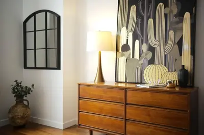 a dresser with a lamp on top of it in a room at HRésidences Modern Condo on MAIN St Laurent Blvd in Montréal