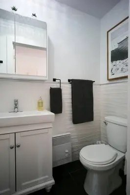 a bathroom with a white toilet and a sink at HRésidences Modern Condo on MAIN St Laurent Blvd in Montréal