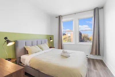 a bedroom with a bed with a stuffed animal on it at Modern and cozy 4 bedrooms sleep 12 in Montréal