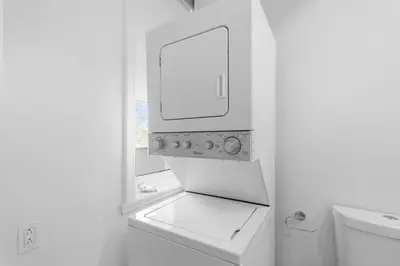 a white bathroom with a sink and a mirror at Modern and cozy 4 bedrooms sleep 12 in Montréal