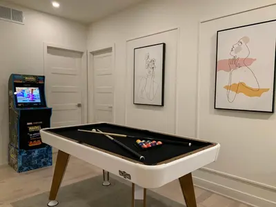a room with a pool table and a television at Modern Lake Champlain Villa with Spa in Venise-en-Québec