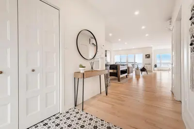 a white room with a mirror on the wall at Modern Lake Champlain Villa with Spa in Venise-en-Québec