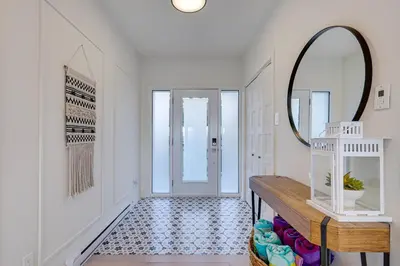 a hallway with a mirror and a wooden table at Modern Lake Champlain Villa with Spa in Venise-en-Québec
