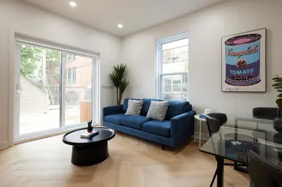 a living room with a blue couch and a table at Chic 2 Bedroom apartment in Le Plateau by Denstays in Montréal