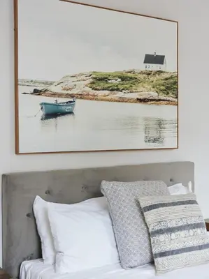 a painting above a bed with a picture above it at Chic 2 Bedroom apartment in Le Plateau by Denstays in Montréal