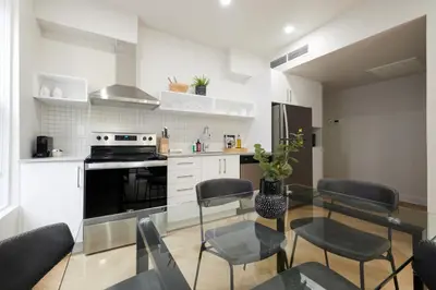 a kitchen with a table and chairs and a stove at Chic 2 Bedroom apartment in Le Plateau by Denstays in Montréal