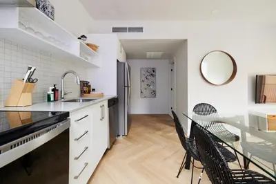 a kitchen with a table and chairs and a mirror at New and Cozy 3 bedroom in Le Plateau by Denstays in Montréal
