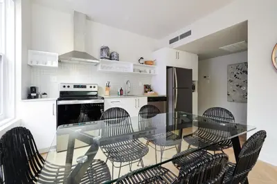 a kitchen with a glass table and chairs at New and Cozy 3 bedroom in Le Plateau by Denstays in Montréal
