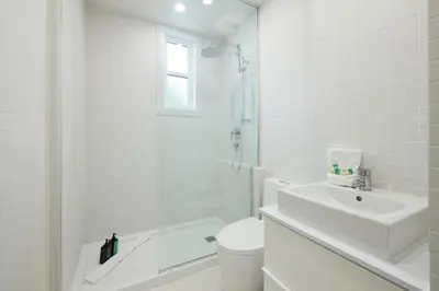 a bathroom with a sink and a toilet and a shower at New and Cozy 3 bedroom in Le Plateau by Denstays in Montréal