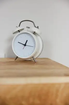 a white clock sitting on top of a wooden table at Spacious 2 bedroom apartment in Le Plateau by Denstays in Montréal