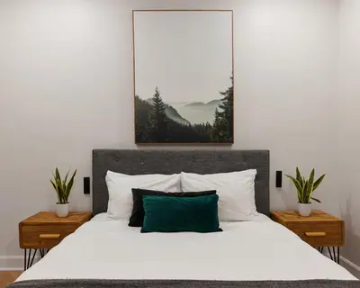 a bedroom with a white bed with a green pillow at Spacious 2 bedroom apartment in Le Plateau by Denstays in Montréal