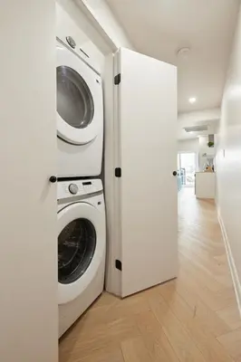 a laundry room with a washer and dryer in it at Urban Gem in Le Plateau by Denstays in Montréal