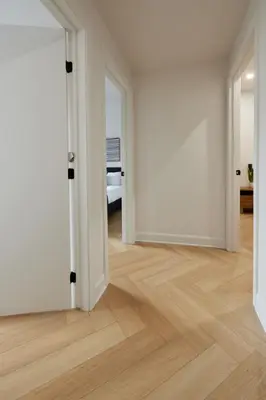 an empty room with an open door and wooden floors at Urban Gem in Le Plateau by Denstays in Montréal