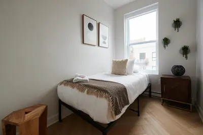 a bedroom with a bed and a window at Urban Gem in Le Plateau by Denstays in Montréal