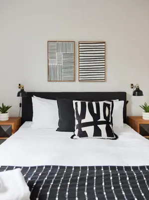 a bedroom with a bed with black and white pillows at Urban Gem in Le Plateau by Denstays in Montréal