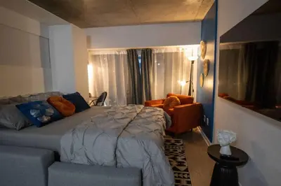 a bedroom with a bed and a couch at Downtown Montreal Premium Cozy Studio in Montréal