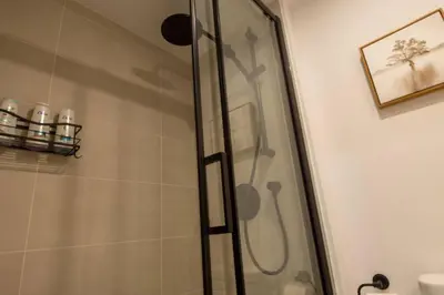 a shower with a glass door in a bathroom at Downtown Montreal Premium Cozy Studio in Montréal