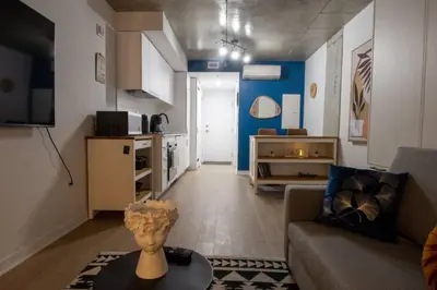 a living room with a couch and a vase on a table at Downtown Montreal Premium Cozy Studio in Montréal