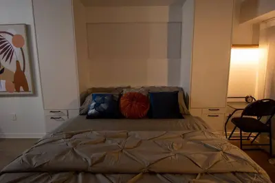 a bedroom with a large bed with pillows on it at Downtown Montreal Premium Cozy Studio in Montréal