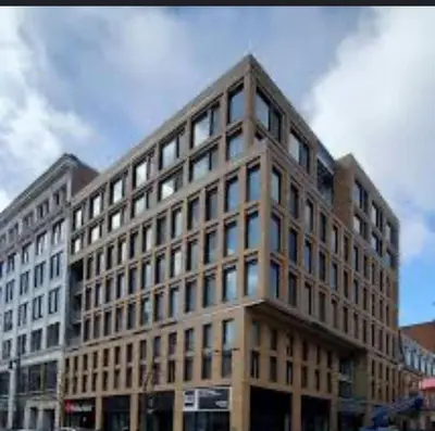a large building with many windows on a street at Downtown Montreal Premium Cozy Studio in Montréal