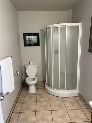 a bathroom with a shower and a toilet at Motel la siesta de gascon in Terrebonne