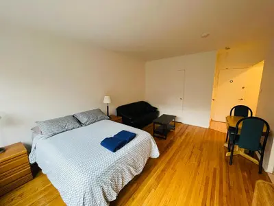 a bedroom with a bed with a blue towel on it at Stylish Montreal Apartment: Comfortable Stay in the Golden Square Mile in Montréal