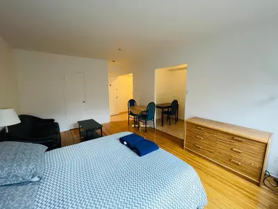 a bedroom with a bed and a table and chairs at Stylish Montreal Apartment: Comfortable Stay in the Golden Square Mile in Montréal