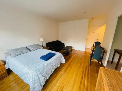 a bedroom with a bed with a blue towel on it at Stylish Montreal Apartment: Comfortable Stay in the Golden Square Mile in Montréal