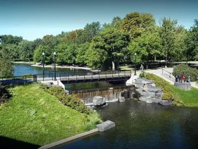a bridge over a river in a park at Chez Mont Royal Apartments! in Montréal