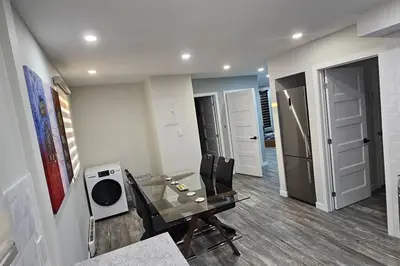 a dining room with a glass table and chairs at Spacious bright Apt,Parking and self check-in in Longueuil