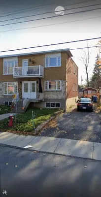 a house with a car parked in front of it at Spacious bright Apt,Parking and self check-in in Longueuil
