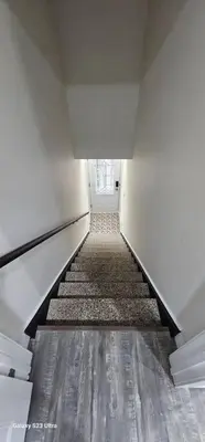 a long hallway with a stairway in a building at Spacious bright Apt,Parking and self check-in in Longueuil