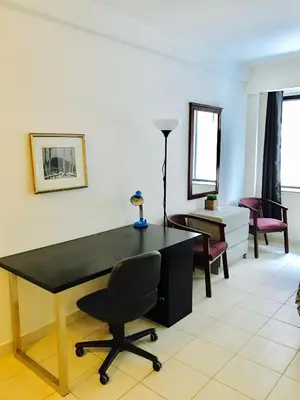 a living room with a black desk and a chair at Stylish Montreal Apartment: Comfortable Stay in the Golden Square Mile in Montréal