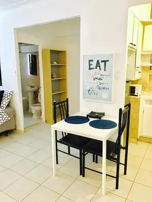 a white table and chairs in a kitchen at Stylish Montreal Apartment: Comfortable Stay in the Golden Square Mile in Montréal