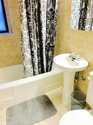 a bathroom with a sink and a shower curtain at Stylish Montreal Apartment: Comfortable Stay in the Golden Square Mile in Montréal