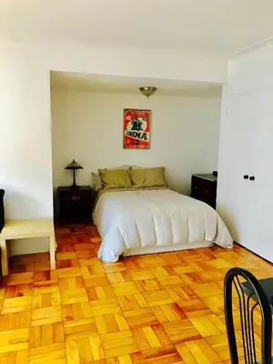 a bedroom with a bed and a wooden floor at Stylish Montreal Apartment: Comfortable Stay in the Golden Square Mile in Montréal