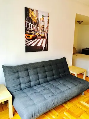 a couch in a room with a picture on the wall at Stylish Montreal Apartment: Comfortable Stay in the Golden Square Mile in Montréal