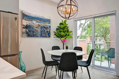 a kitchen and dining room with a table and chairs at Penthouse Downtown 2BR 2 BR Private Roof Terrace presented by TripMontreal in Montréal