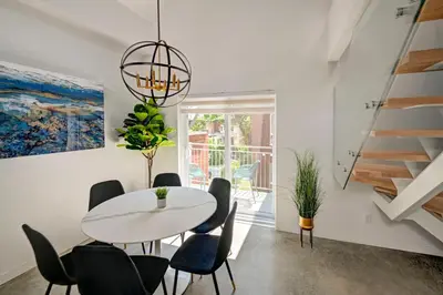 a dining room with a white table and chairs at Penthouse Downtown 2BR 2 BR Private Roof Terrace presented by TripMontreal in Montréal
