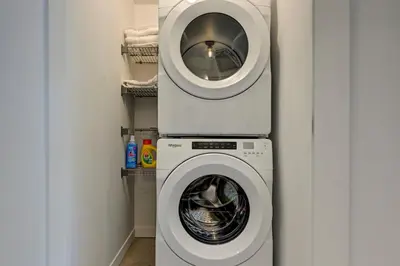 a washing machine in a laundry room with a washer at Penthouse Downtown 2BR 2 BR Private Roof Terrace presented by TripMontreal in Montréal