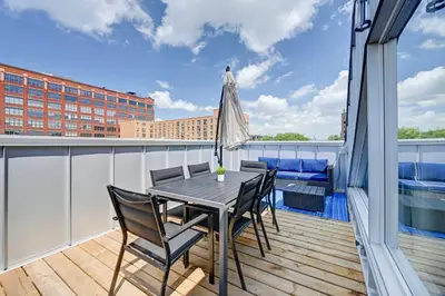 a patio with a table and chairs on a balcony at Penthouse Downtown 2BR 2 BR Private Roof Terrace presented by TripMontreal in Montréal