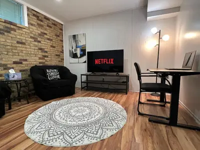 a living room with a couch and a table at Bertha's charming urban retreat in Laval